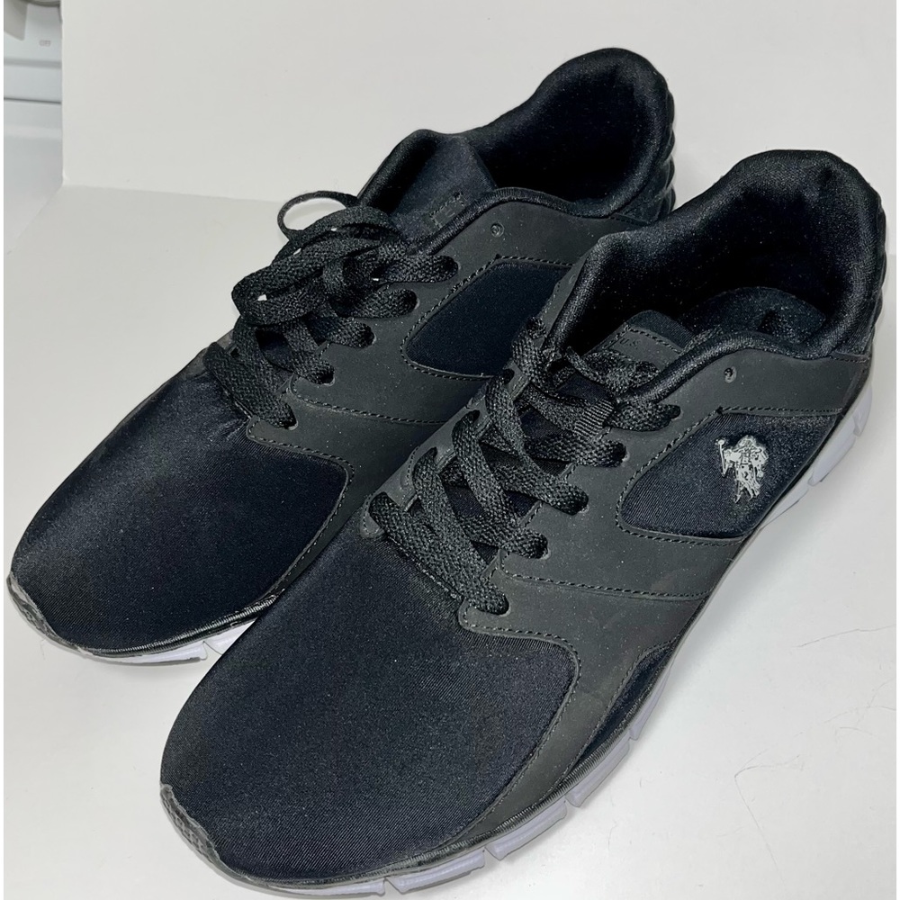 Women’s size 11 athletic shoe. U.S. Polo Assn. Black w/white soles. Med width.